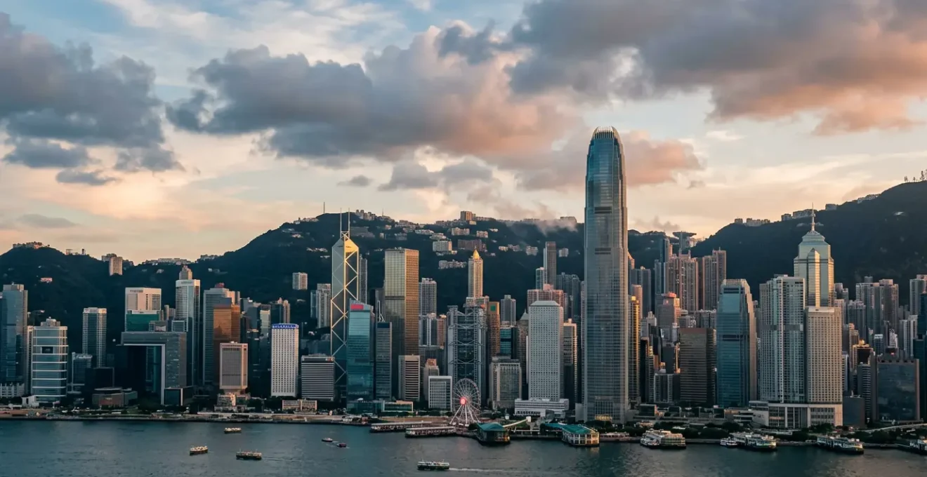 Panoramic view of Hong Kong Central district iconic skyscrapers against Victoria Harbour waterfront with modern architectural landmarks