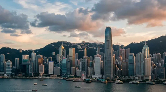 Panoramic view of Hong Kong Central district iconic skyscrapers against Victoria Harbour waterfront with modern architectural landmarks