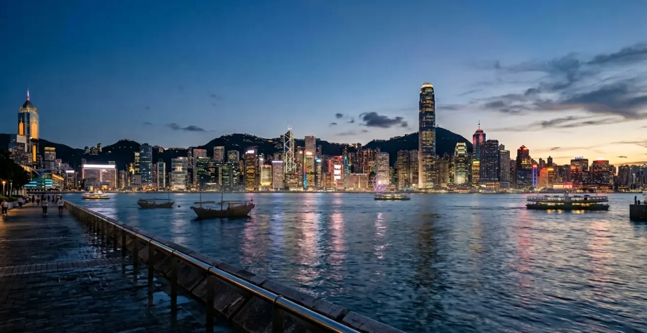 Hong Kong skyline at dusk with modern skyscrapers reflecting in Victoria Harbour, representing connectivity and travel preparation