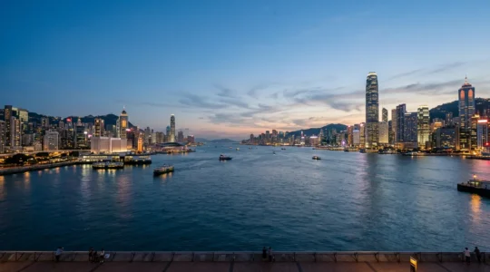 Panoramic view of Victoria Harbour with Kowloon and Hong Kong Island skylines facing each other across the water