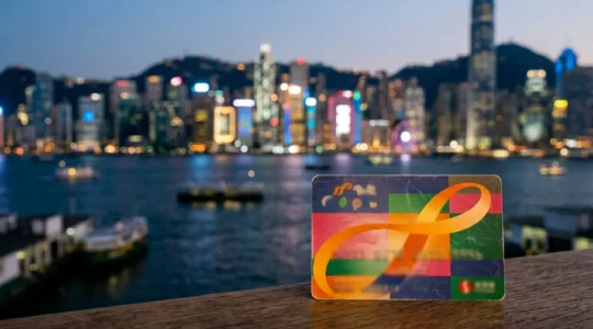 Close-up view of Hong Kong Octopus card against blurred iconic cityscape background