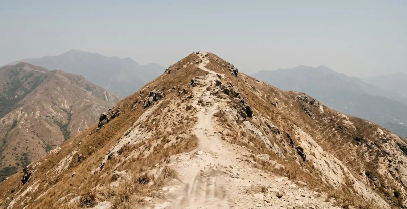 Wide angle view of Dragon's Back exposed ridge under harsh midday sun with no tree cover emphasizing heat exposure risk