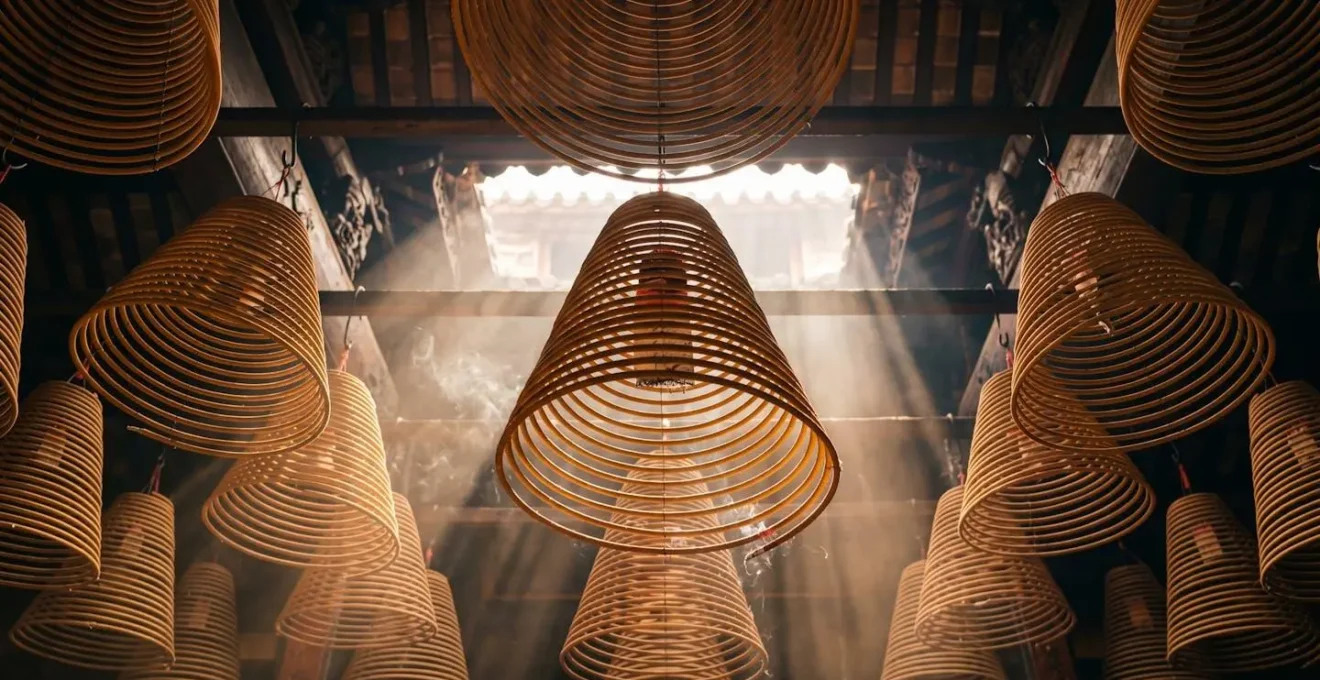 Massive spiral incense coils hanging from temple ceiling creating atmospheric smoke in traditional Hong Kong Taoist temple