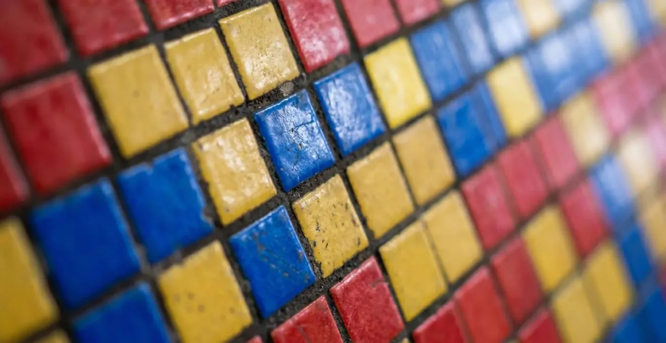 Vibrant mosaic tile pattern on Hong Kong MTR station wall showcasing color-coding design system