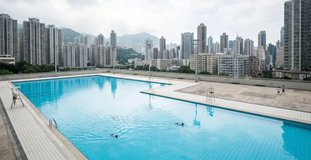 Wide shot of Hong Kong public swimming pool with city skyline showing cooling infrastructure