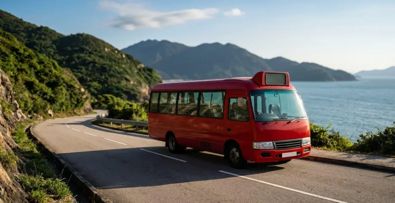Red public minibus traveling along coastal road near Big Wave Bay Hong Kong