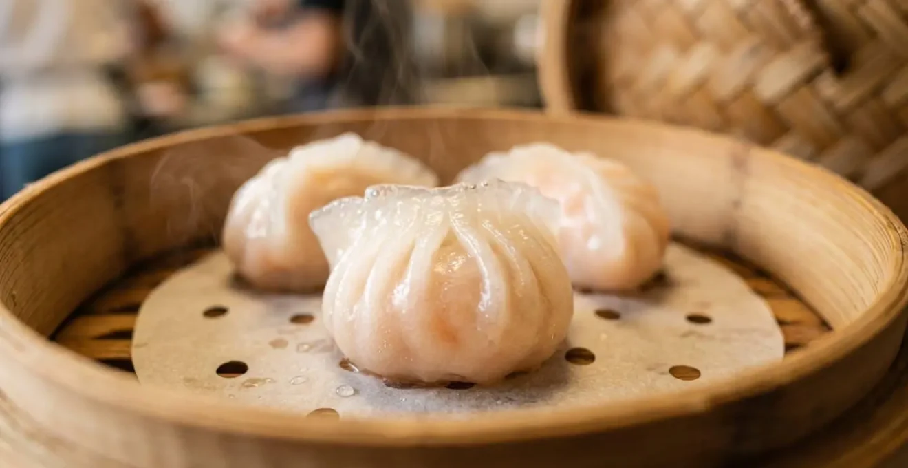 Macro close-up of freshly steamed dim sum dumplings in traditional bamboo steamer basket, shallow depth of field