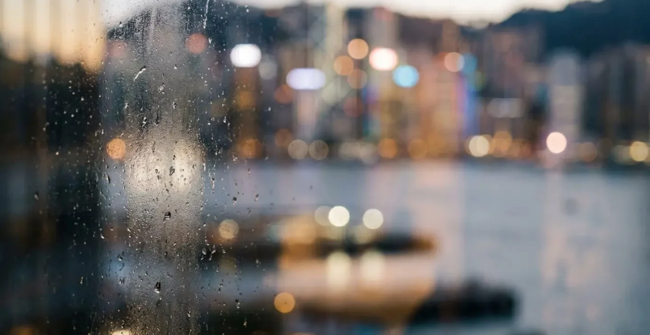 Close-up view through modern hotel window showcasing unobstructed Victoria Harbour panorama
