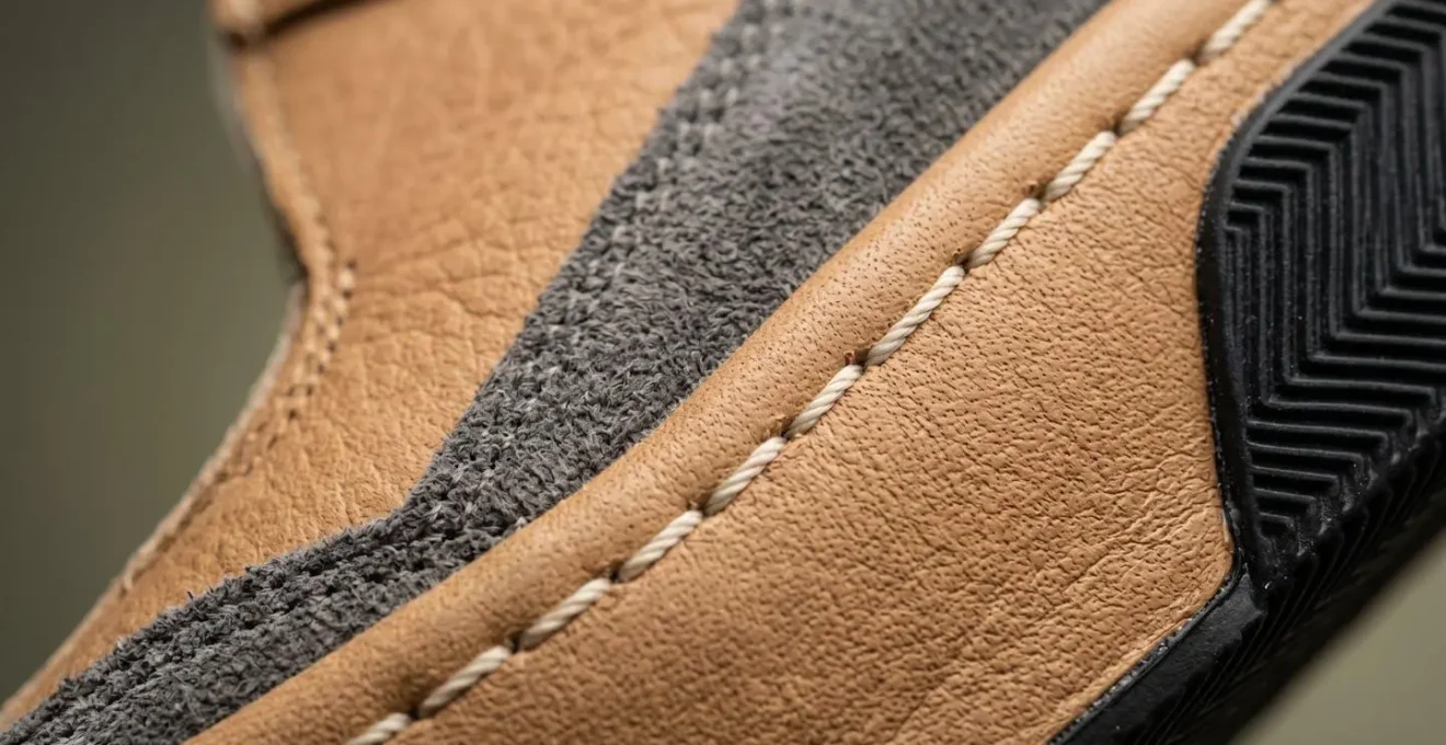 Extreme close-up of sneaker stitching and material texture for authentication inspection