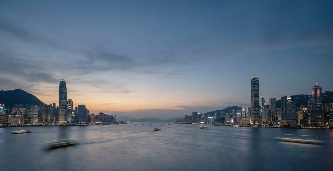 Sweeping wide-angle twilight view of Victoria Harbour skyline with illuminated skyscrapers